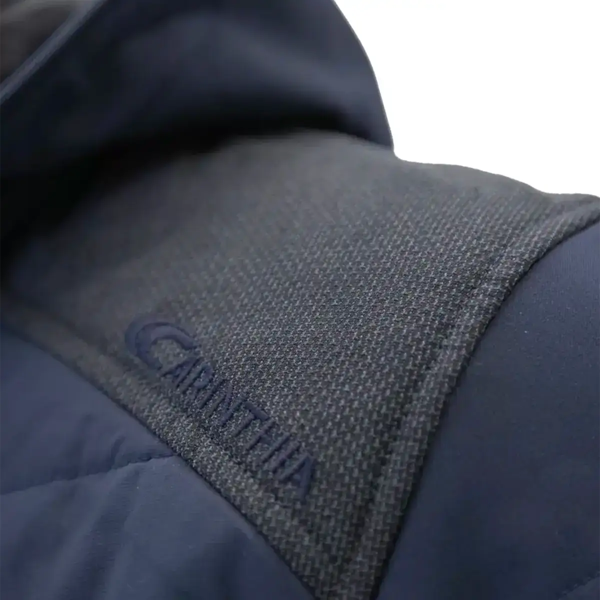 Close-up of fabric tag with 'GORE-TEX' branding on navy blue Carinthia G-Loft ISG PRO jacket, indicating waterproof technology from John Bull Clothing