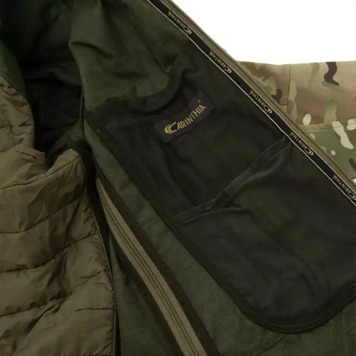 Interior view of Carinthia tactical jacket showing black lining, brand label, and spacious pocket for gear storage from John Bull Clothing