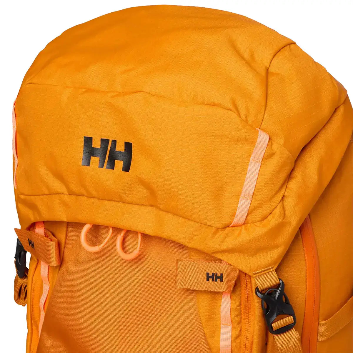Detail of orange Helly Hansen Alpine SAR 45 rescue backpack with black padded back panel, adjustable waist strap, and reflective accents from John Bull Clothing