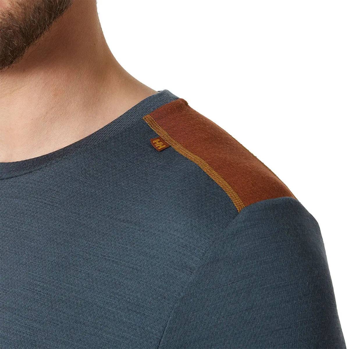 Close-up of Helly Hansen Lifa Merino Midweight Crew Base Layer shoulder detail, showcasing brown contrast stitching and durable fabric construction.