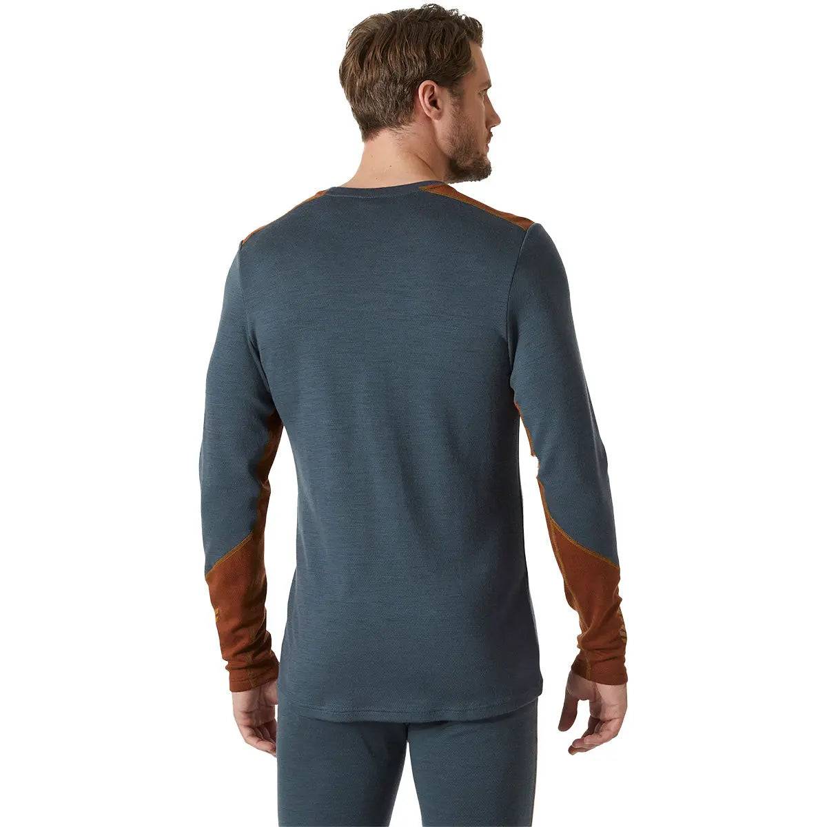 Back view of model wearing Helly Hansen Lifa Merino Midweight Crew Base Layer in dark teal, displaying ergonomic fit and durable fabric construction.