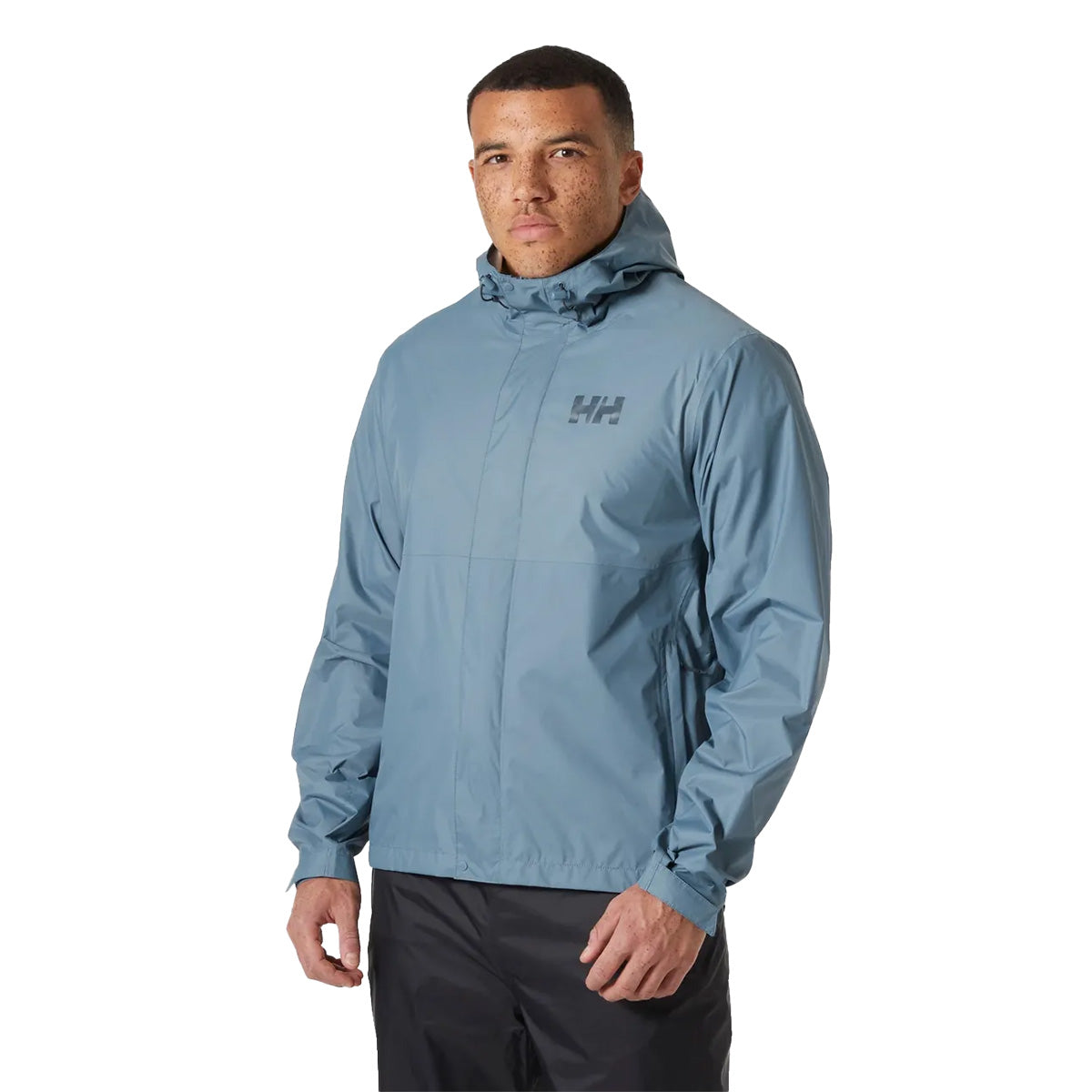 Model wearing Helly Hansen Mens Loke 2.0 Waterproof Jacket in light blue, demonstrating fit and urban outdoor style.