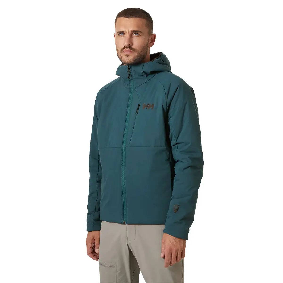 Model wearing the Helly Hansen Odin Stretch Hood Insulator 2.0 Jacket in teal, demonstrating its stylish fit, insulated hood, and functional outdoor design.