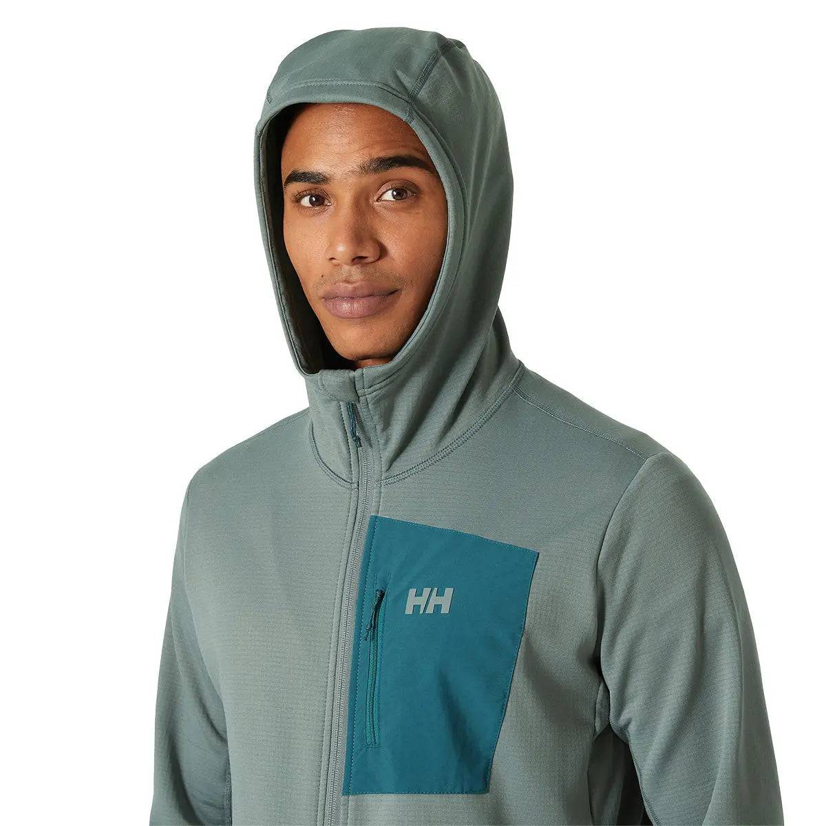 Model wearing the Helly Hansen Versalite Hooded Fleece Jacket in green, showcasing the hooded design and zippered chest pocket for functionality.