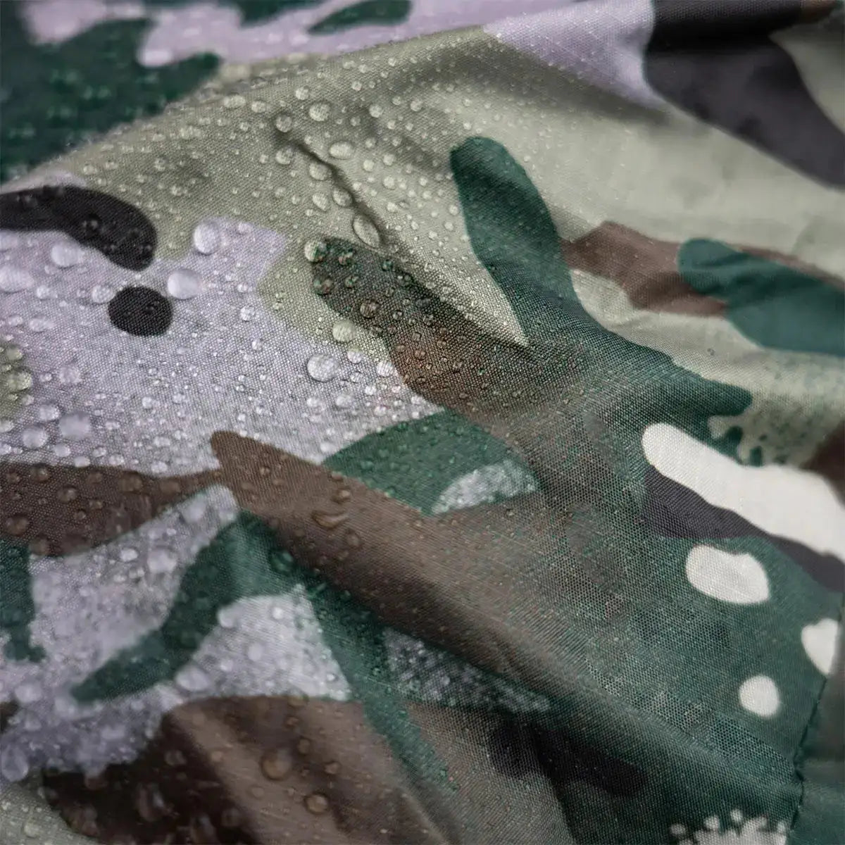 Close-up of Highlander Duck's Back Raincover Medium showing water droplets on durable 70D ripstop nylon fabric for waterproof performance. from John Bull Clothing