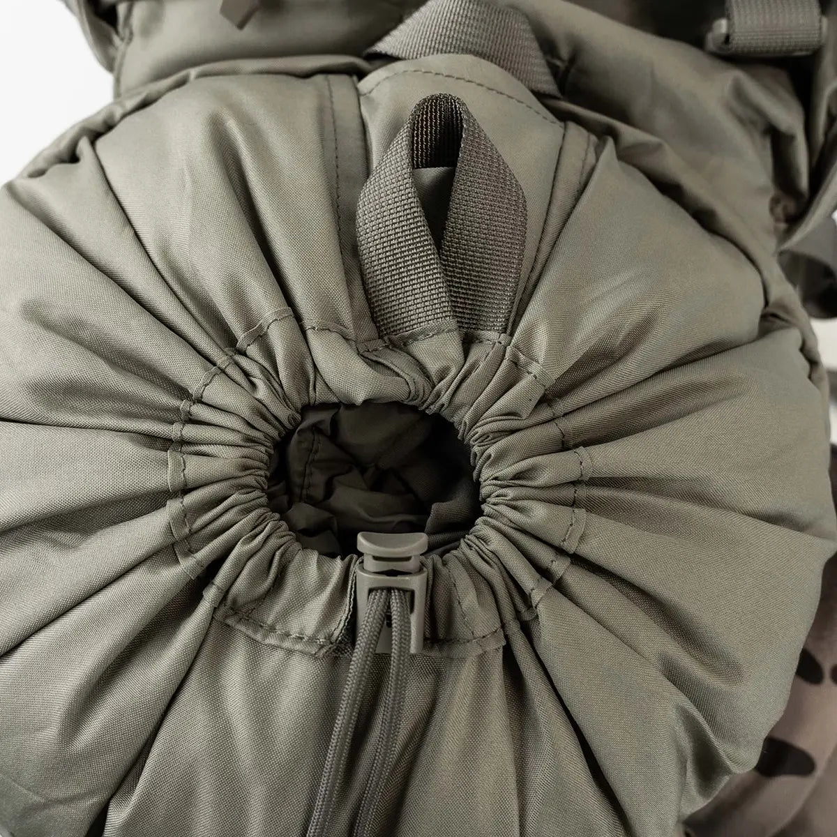 Close-up of drawstring closure on olive Highlander Forces Elite 33 Litre Rucksack, highlighting secure and expandable top-loading design.