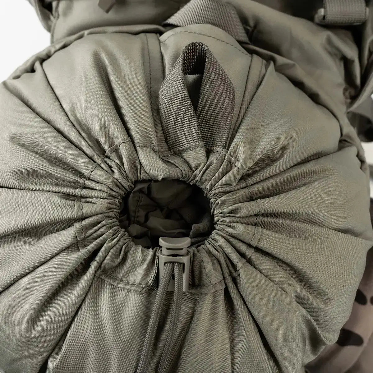 Close-up of drawstring closure on olive Highlander Forces Elite 33 Litre Rucksack, highlighting secure and expandable top-loading design. from John Bull Clothing
