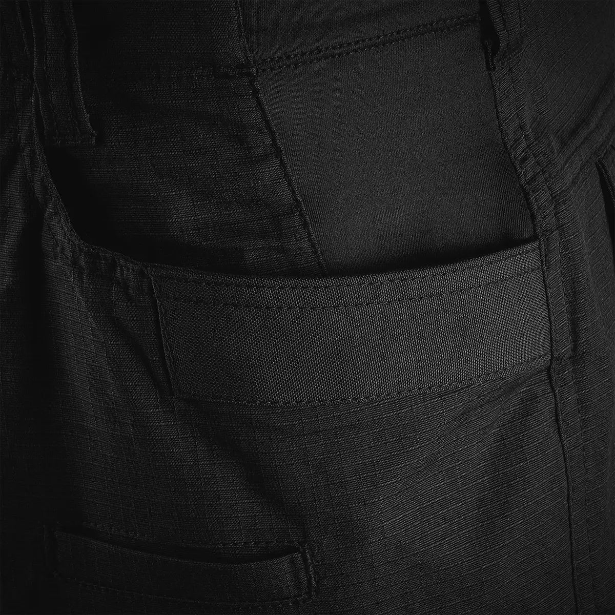 Detail of the front pocket on Highlander Magnum Teflon Trousers, showing reinforced seams and rugged fabric for durability.