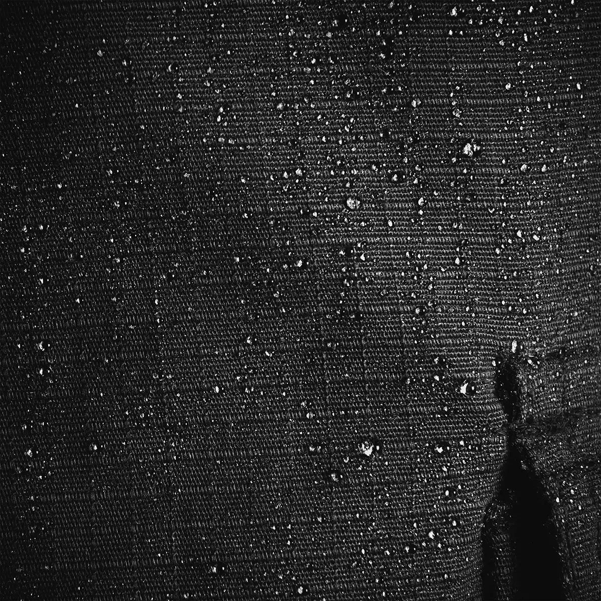 Water droplets on the Teflon-coated ripstop fabric of Highlander Magnum Trousers, demonstrating water-resistant performance.