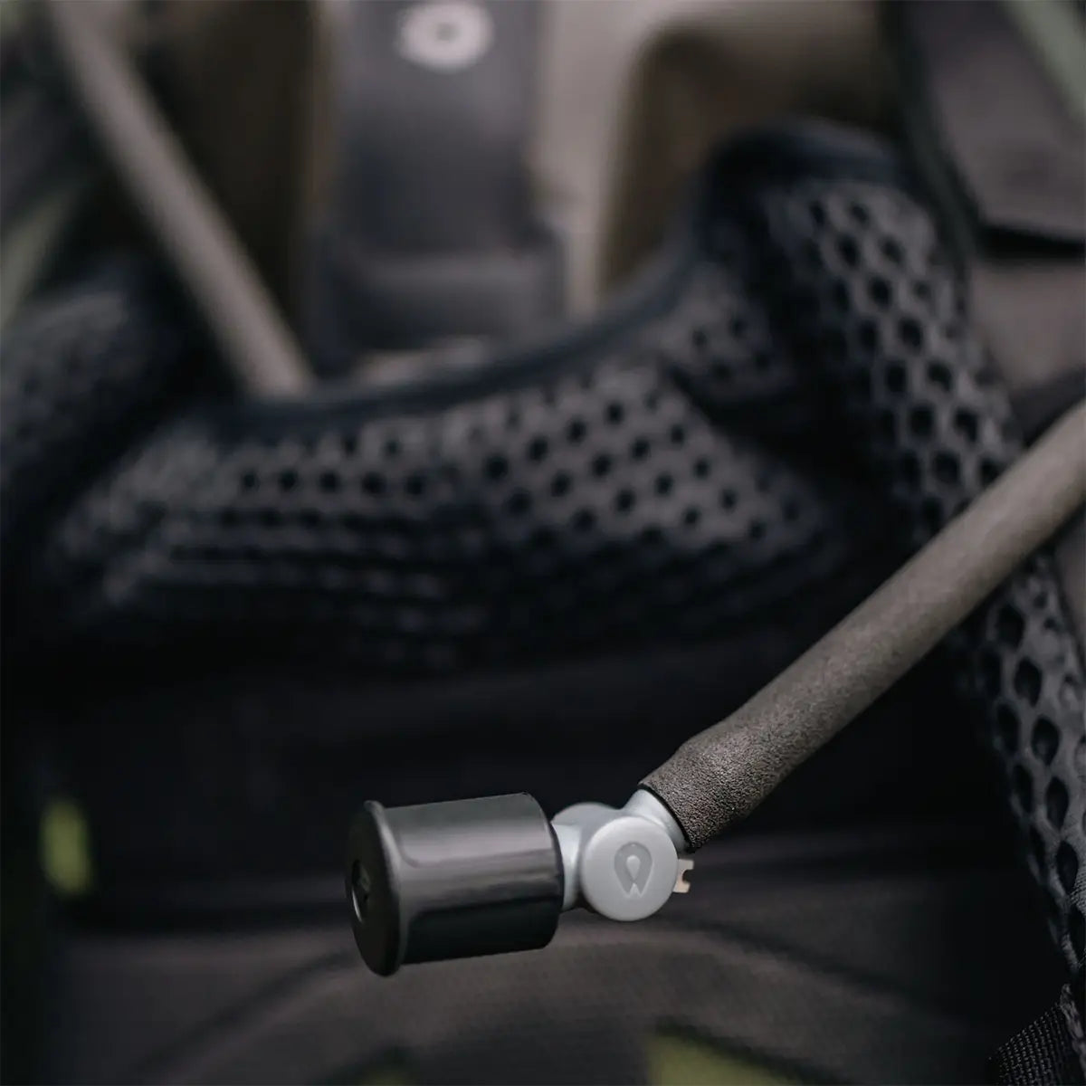 Close-up of HydraPak Force Tactical Grey Water Reservoir bite valve with dust cover, attached to backpack strap | John Bulls