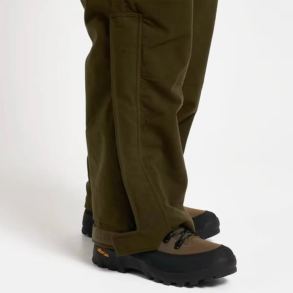 Close-up of lower leg and boot area of Jack Pyke Hunters Trousers Green Waterproof, showing reinforced seams and durable fabric.
