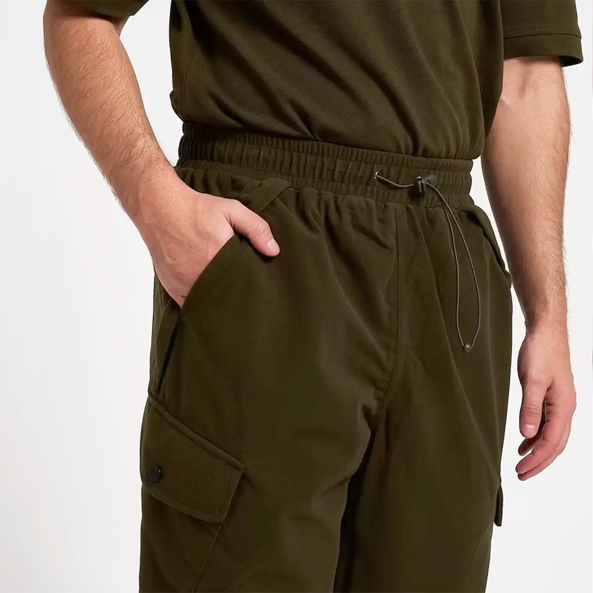 Elastic waistband and front pocket detail of Jack Pyke Hunters Trousers Green Waterproof, designed for comfort and utility in the field.