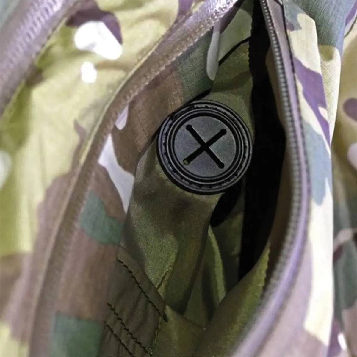 Close-up of the Keela Thor Waterproof Multicam Jacket's internal pocket with a cable pass-through port for secure and convenient device storage.