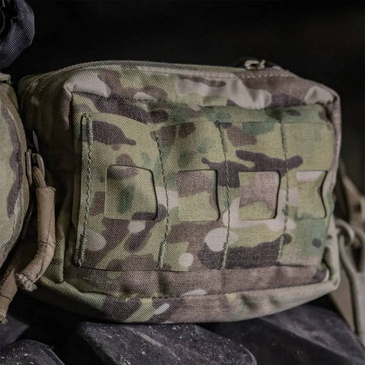 Close-up of the Luminae Multicam Small GP Pouch MTP mounted on gear, showing its rugged Cordura fabric and MOLLE attachment system.