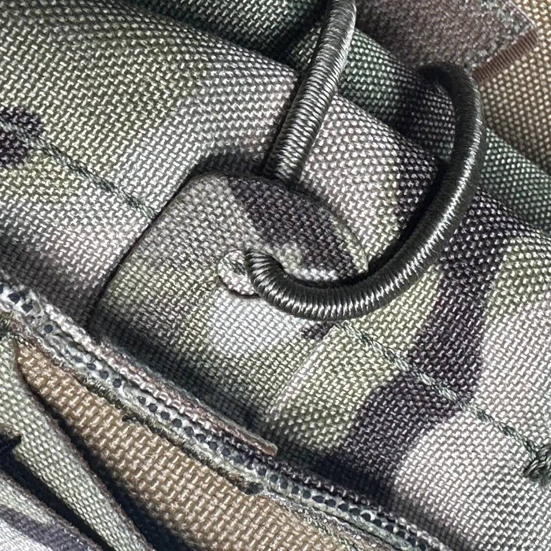 Close-up of the Luminae Multicam Mega Pouch MTP’s reinforced stitching and elastic cord retention, ensuring durability and secure storage in the field.