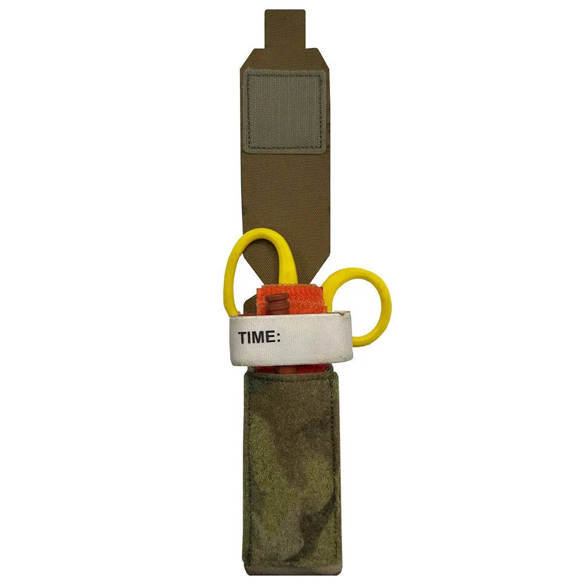 Open Luminae Multicam TQ Pouch MTP displaying a tourniquet and medical shears inside. Designed for quick access in emergency situations.