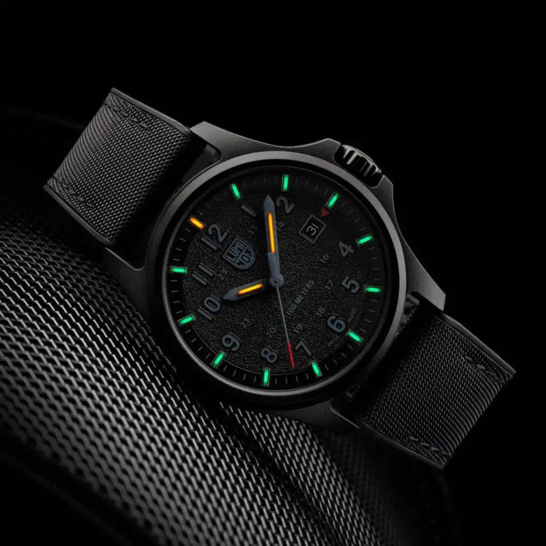 Luminox Atacama Field 1960 Series Watch Black 43mm XL.1961 in a dark setting, showcasing its glowing green and orange self-powered illumination.