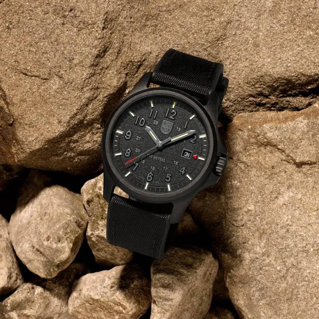 Luminox Atacama Field 1960 Series Watch Black 43mm XL.1961 resting on rugged terrain, emphasizing its durable design and field-ready aesthetics.