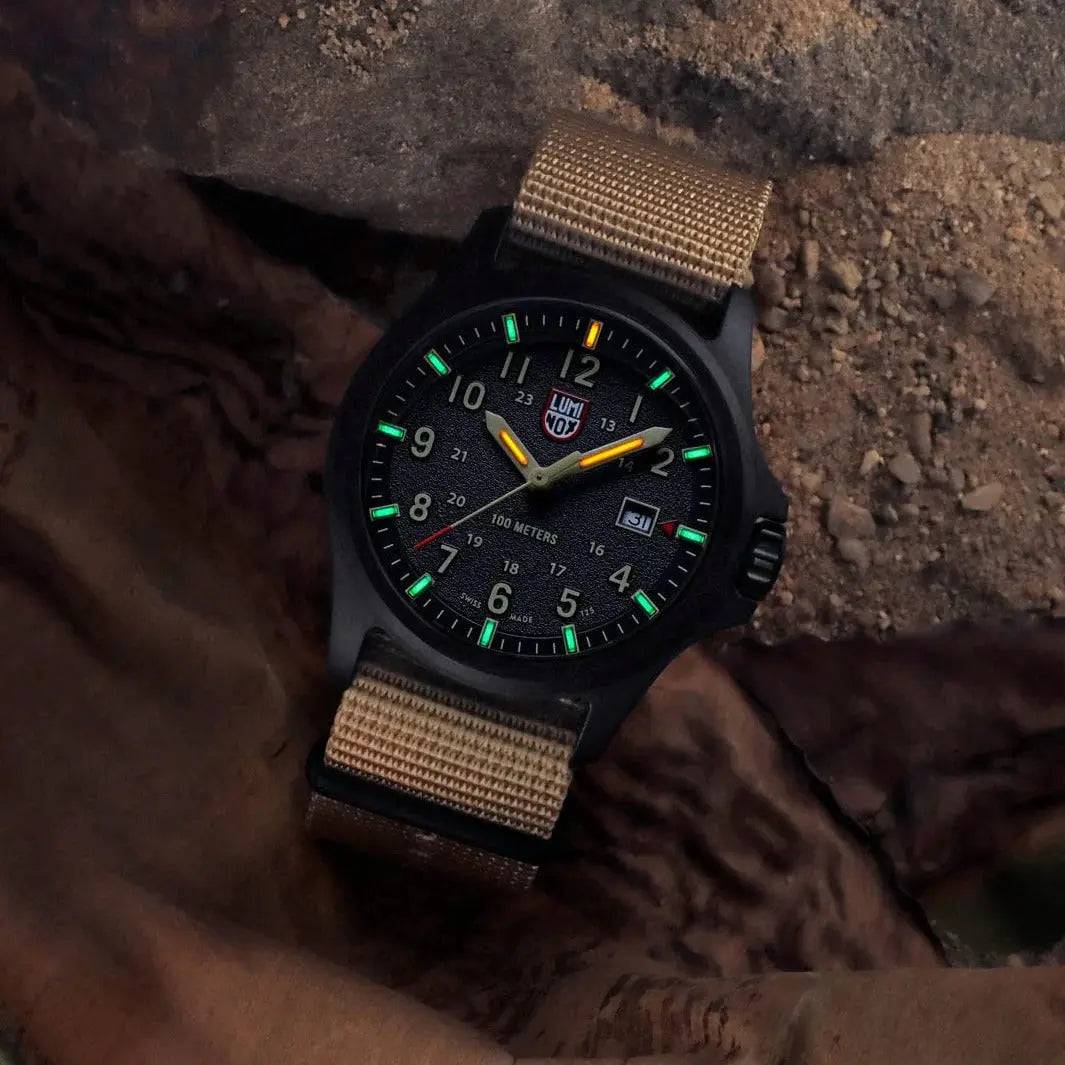 Luminox Atacama Field 1960 Series Watch XL.1970.SET with a sand-colored strap, placed on rugged terrain, emphasizing its outdoor and adventure-ready design.