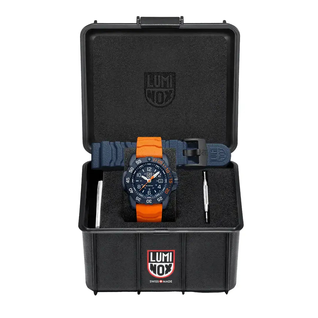 Luminox watch in protective black case with orange and navy blue strap, featuring a blue dial, date window, and Luminox logo