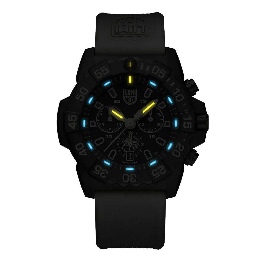 Luminox Navy SEAL Foundation Chronograph Dive Watch glowing in the dark with blue and yellow luminescent markers for enhanced visibility.