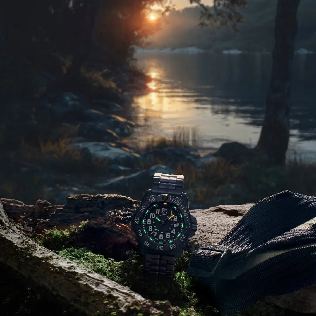 Luminox Navy Seal Military Black Dive Watch 45mm XS.3510 glowing in outdoor setting at dusk, emphasizing its tactical and adventure-ready design.