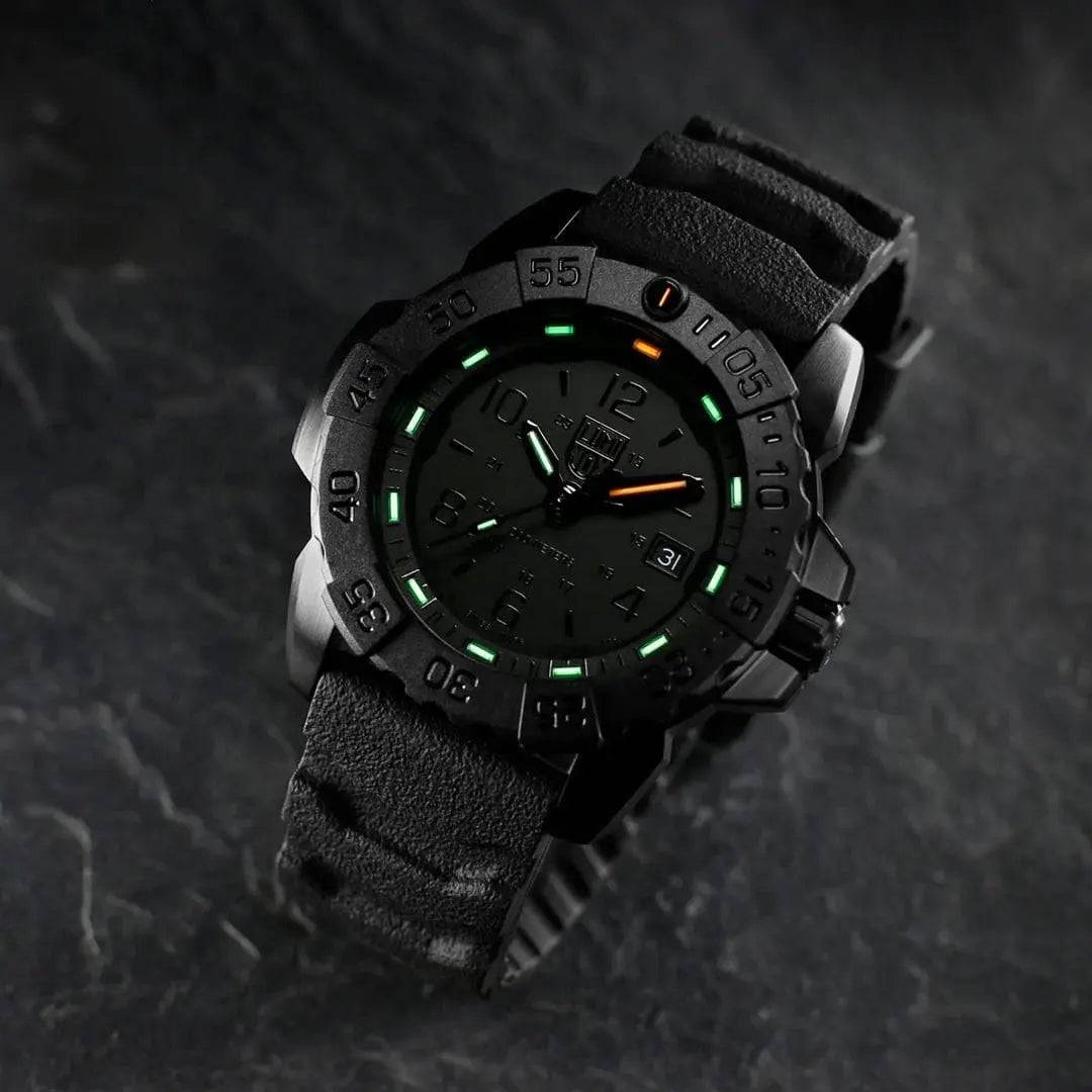 Luminox Navy Seal Steel 3250 Series Black 45mm XS.3251.BO.CB tactical watch with luminous markers, placed on a dark textured surface for a rugged look.