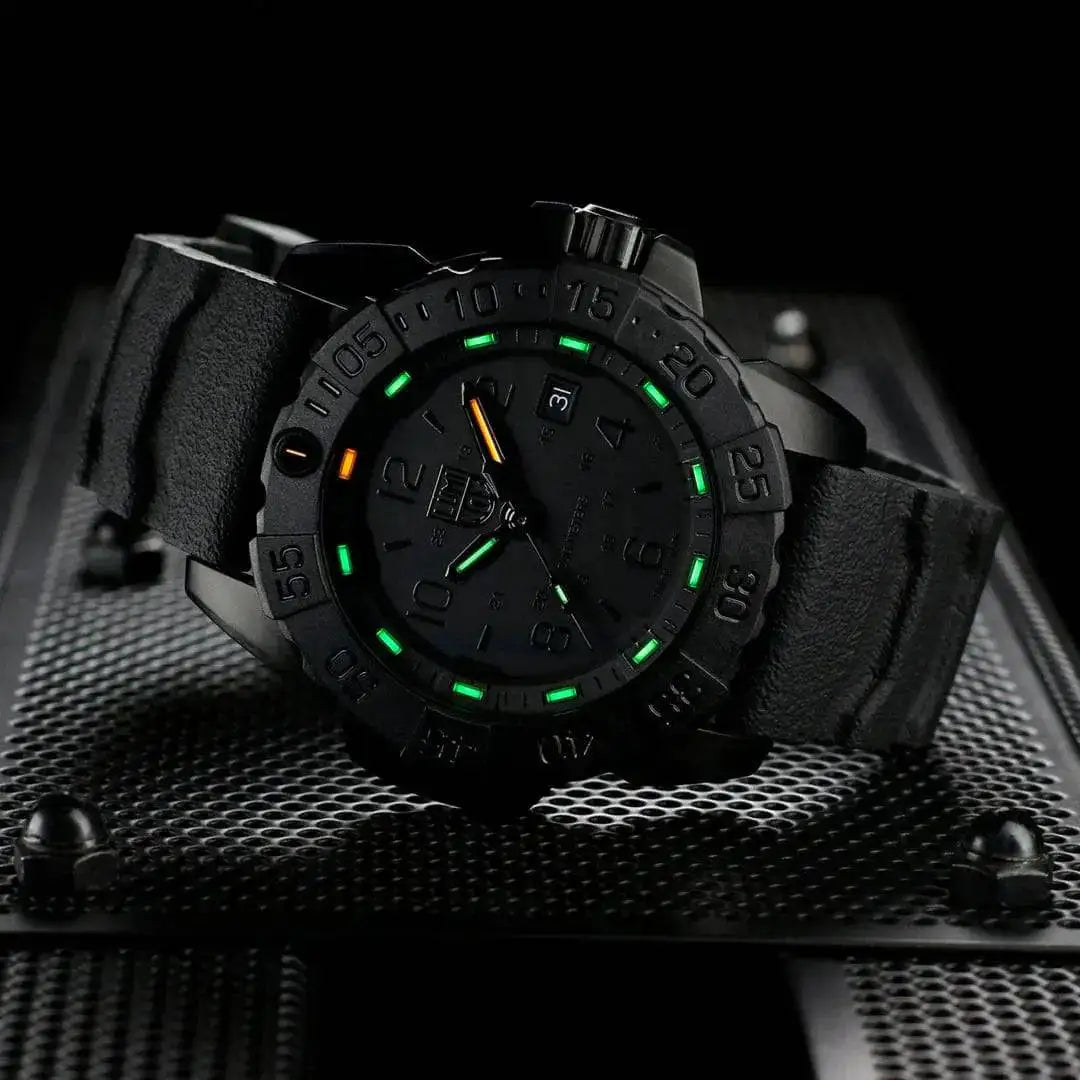 Luminox Navy Seal Steel 3250 Series Black 45mm XS.3251.BO.CB watch displayed on a metal surface, highlighting its robust design and night visibility. from John Bull Clothing