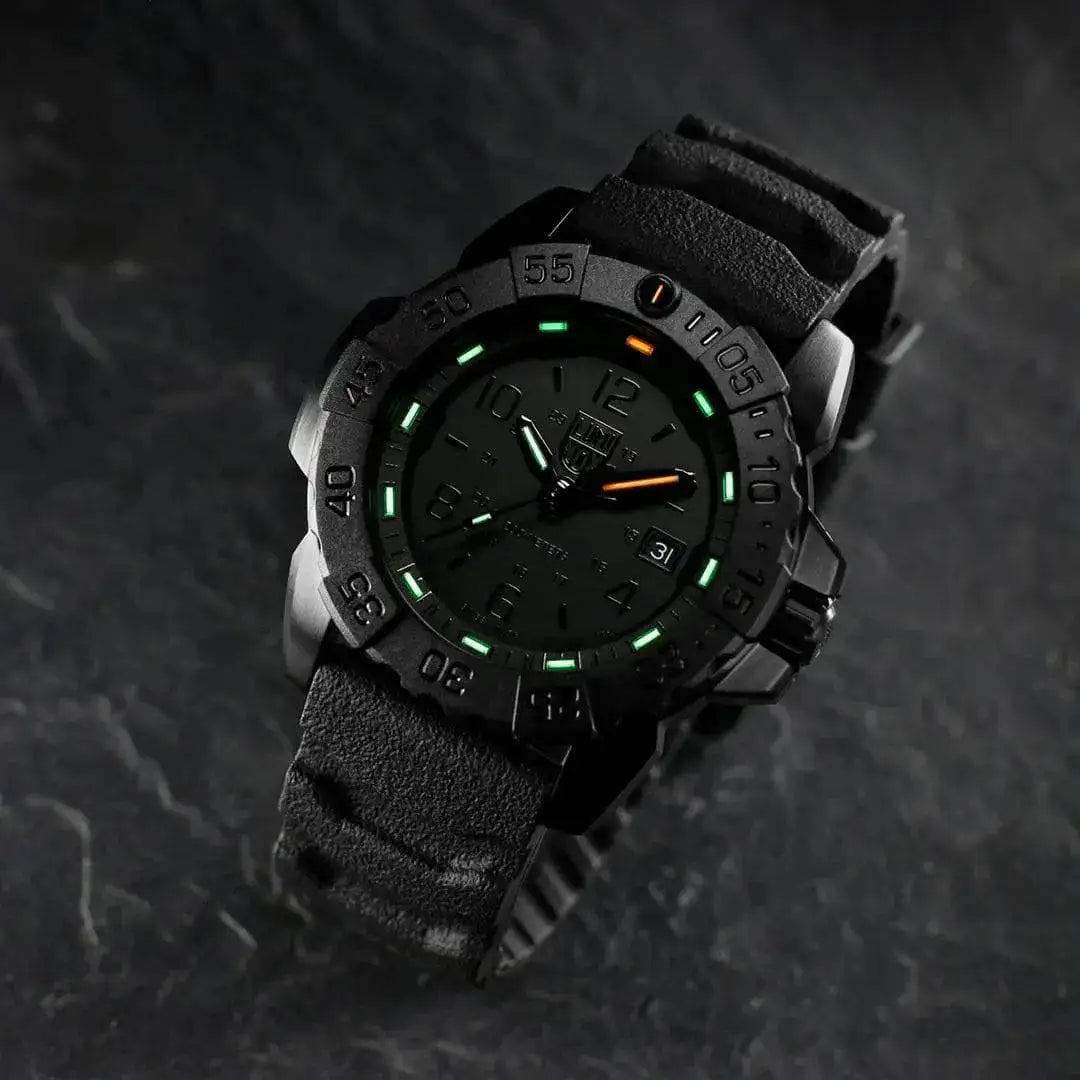Luminox Navy Seal Steel 3250 Series Black 45mm XS.3251.BO.CB tactical watch with luminous markers, placed on a dark textured surface for a rugged look. from John Bull Clothing