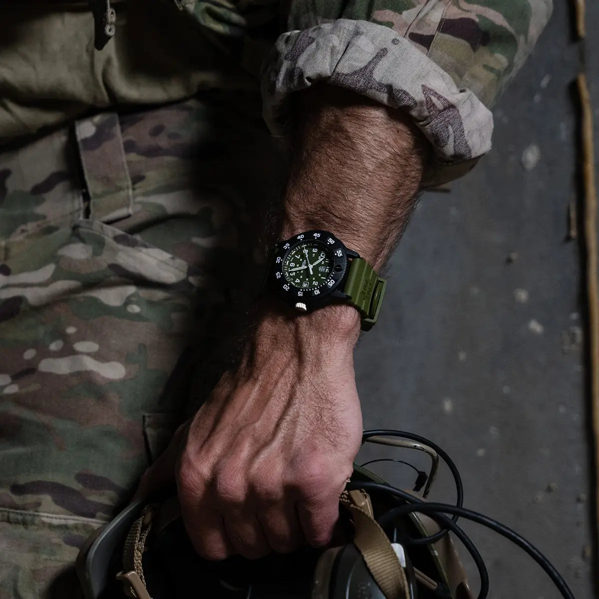 Luminox Navy Seal 3001 Dive Watch worn on wrist with military gear, showcasing its tactical design and outdoor durability.