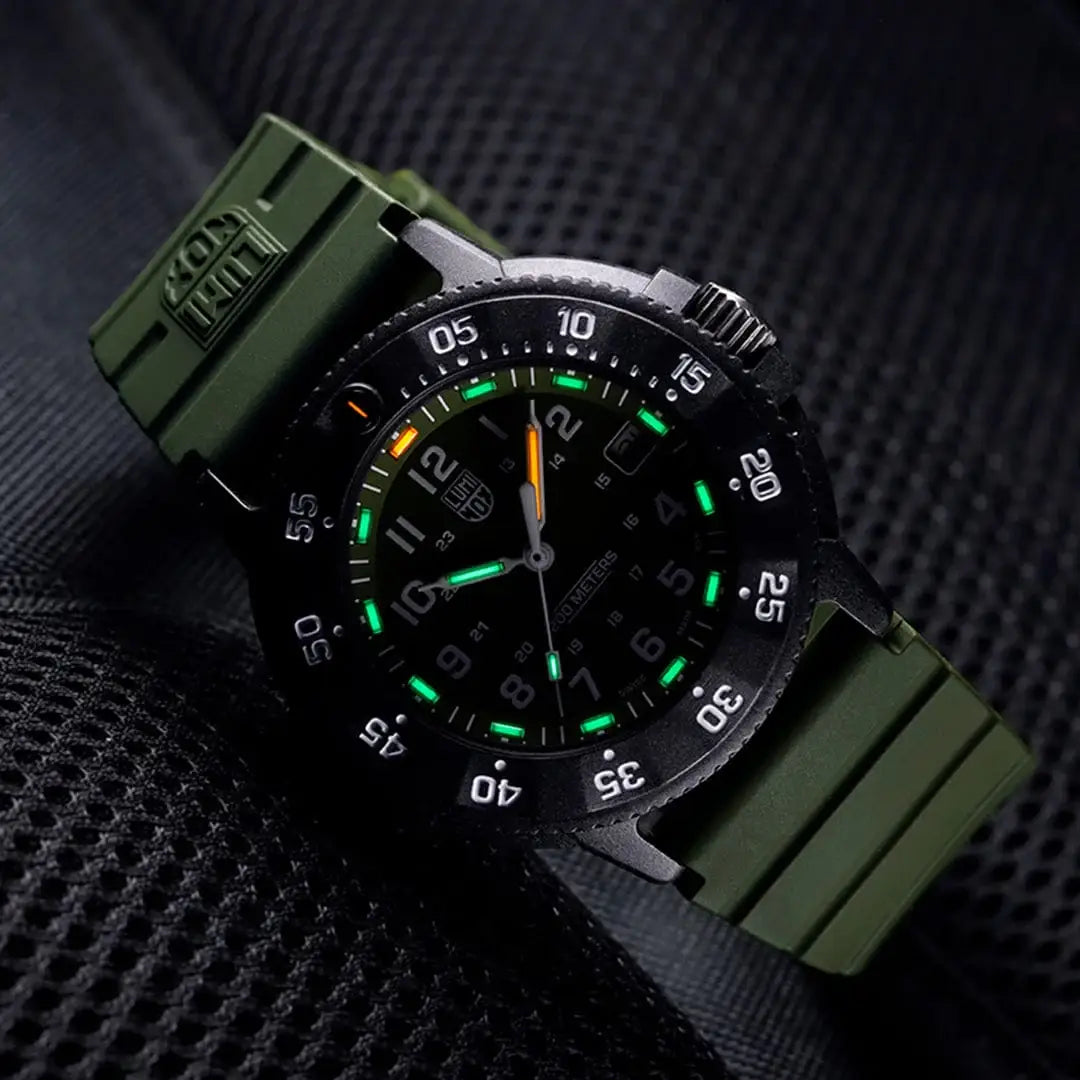 Angled view of Luminox Navy Seal 3001 Dive Watch glowing in the dark, emphasizing its tactical style and luminous markers.