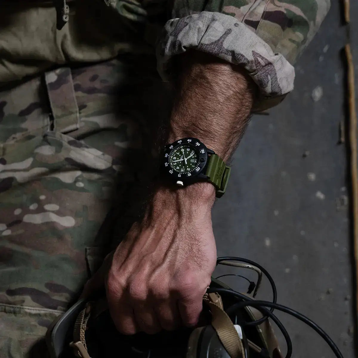 Luminox Navy Seal 3001 Dive Watch worn on wrist with military gear, showcasing its tactical design and outdoor durability. from John Bull Clothing