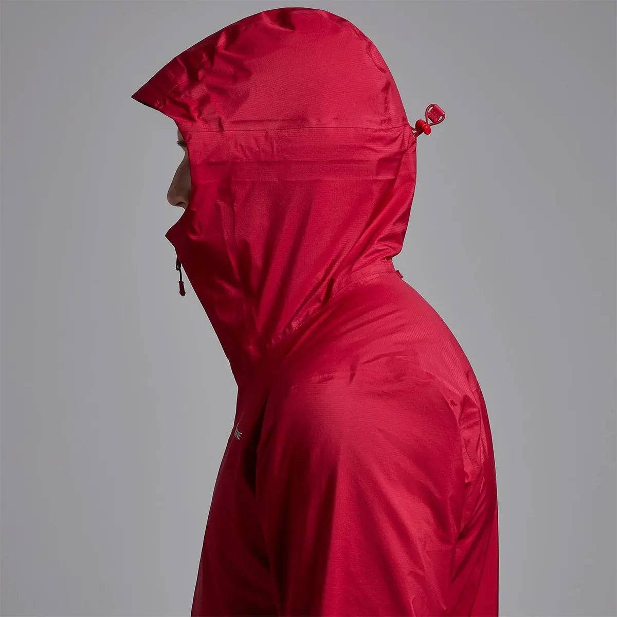 Close-up side view of Montane Mens Cetus Lite Waterproof Jacket in red, highlighting the adjustable hood with a secure drawcord system.