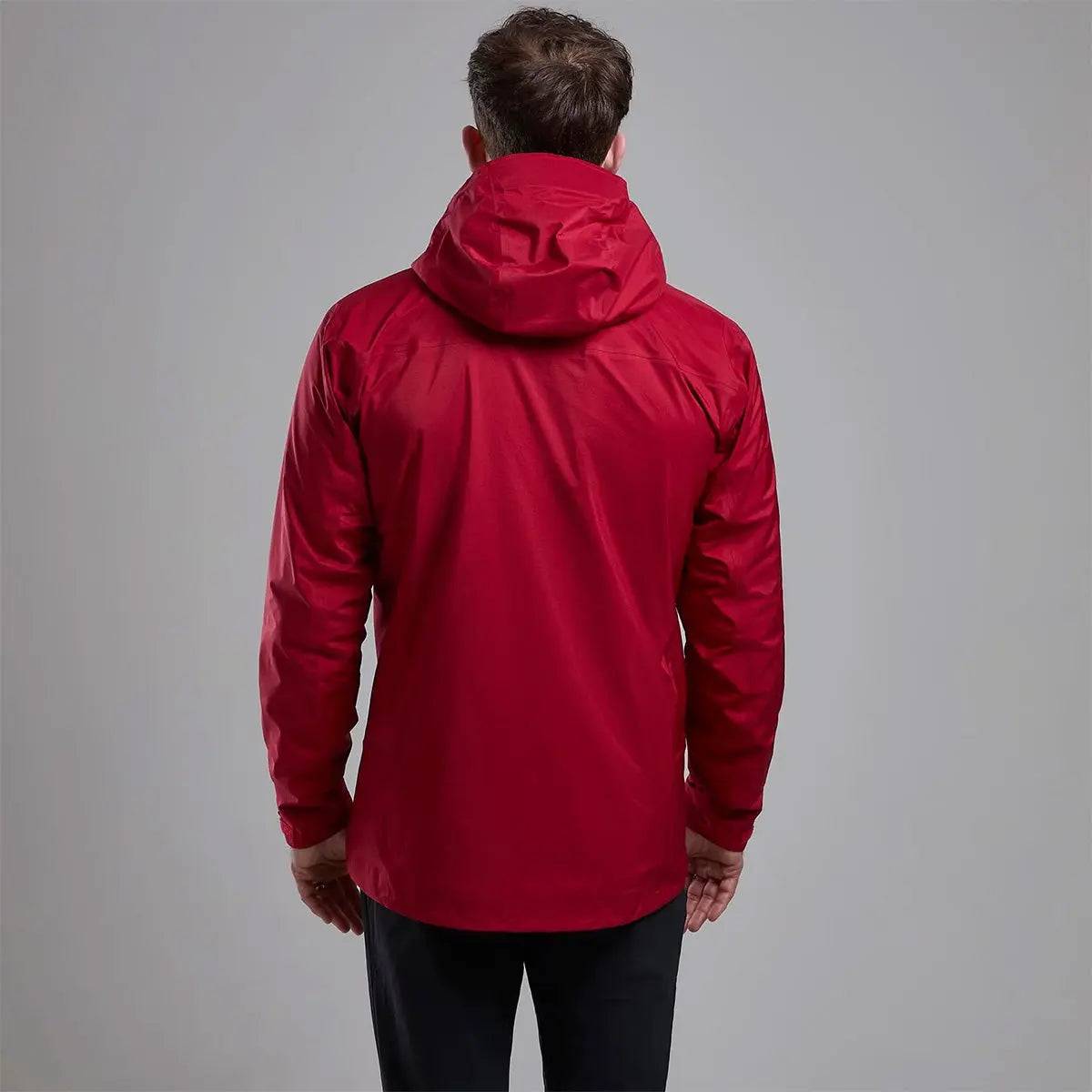 Back view of Montane Mens Cetus Lite Waterproof Jacket in red, highlighting the ergonomic fit and protective hood for full coverage in wet conditions.
