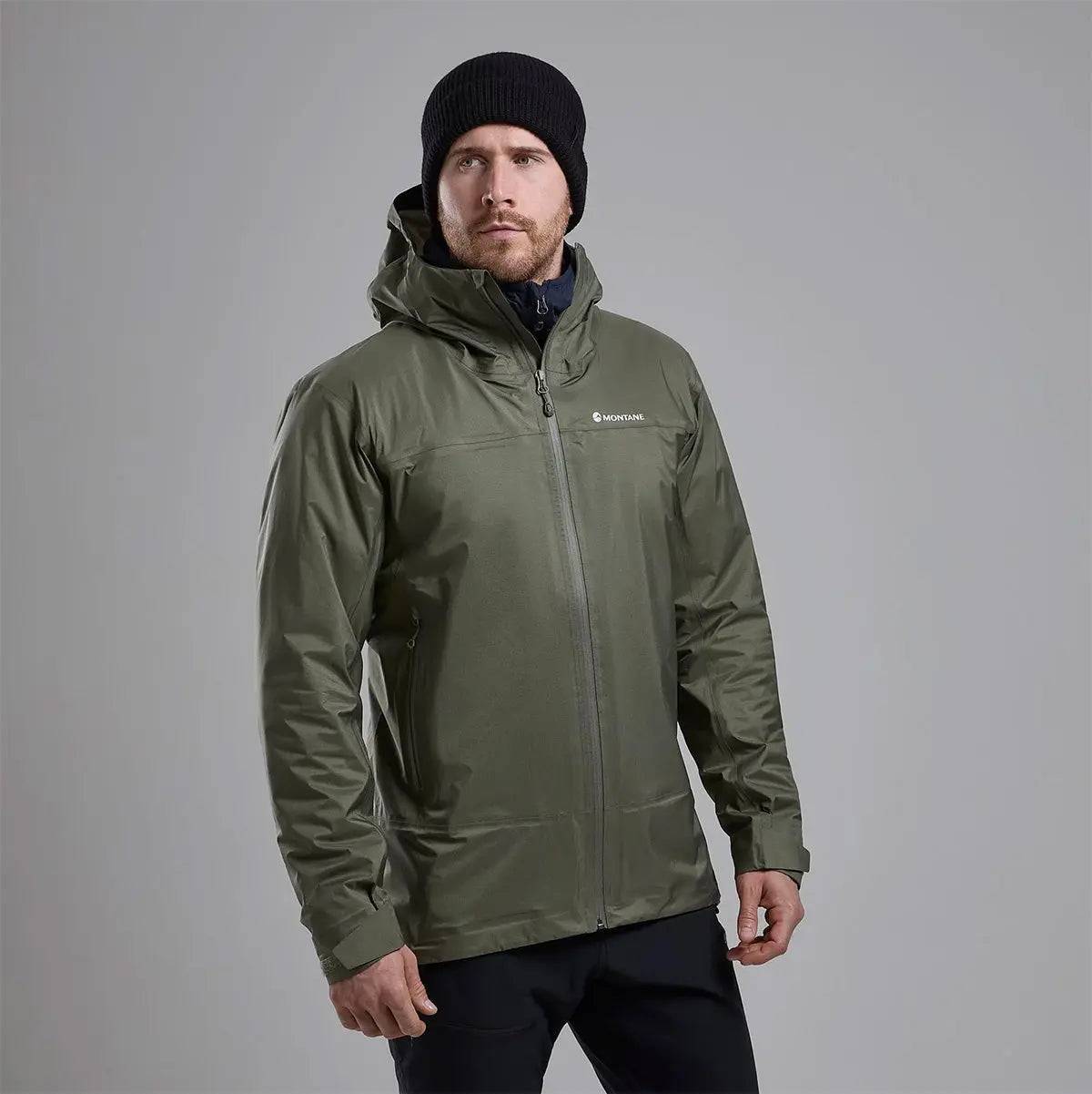 Model wearing Montane Mens Cetus Lite Waterproof Jacket in olive green, showcasing its comfortable fit and weather-resistant features.