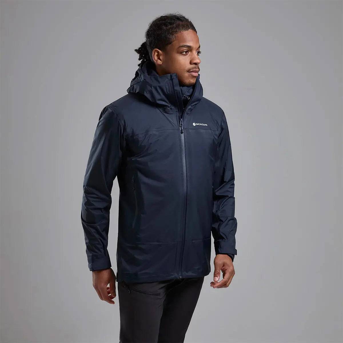 Model wearing Montane Mens Cetus Lite Waterproof Jacket in black, demonstrating its versatile fit and durable waterproof fabric for outdoor use.