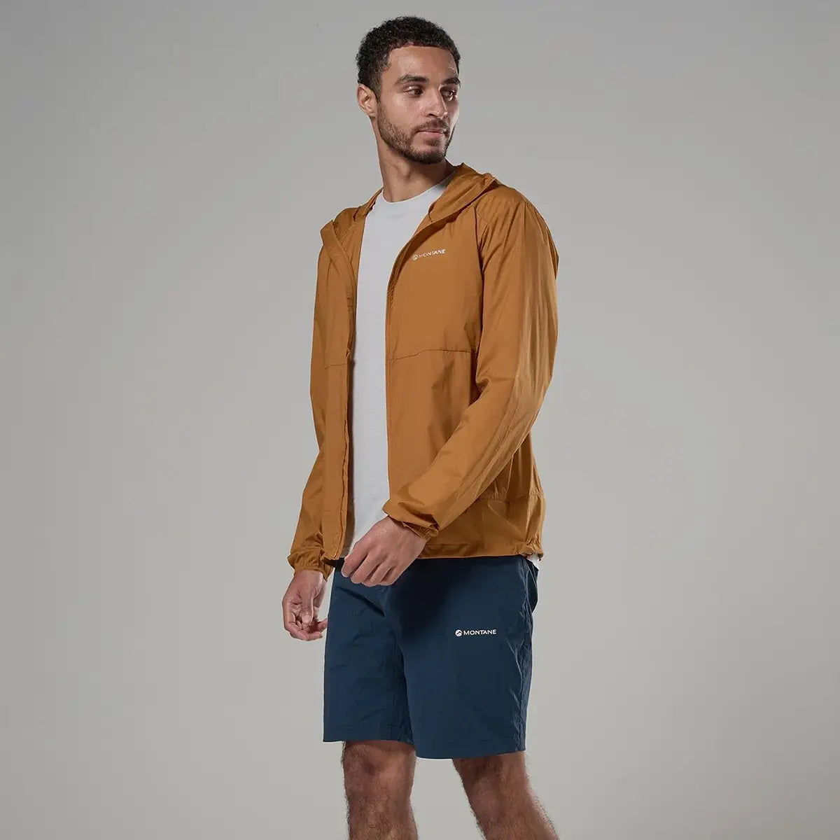 Men wearing tan hooded windbreaker jacket, outdoor apparel for wind resistance