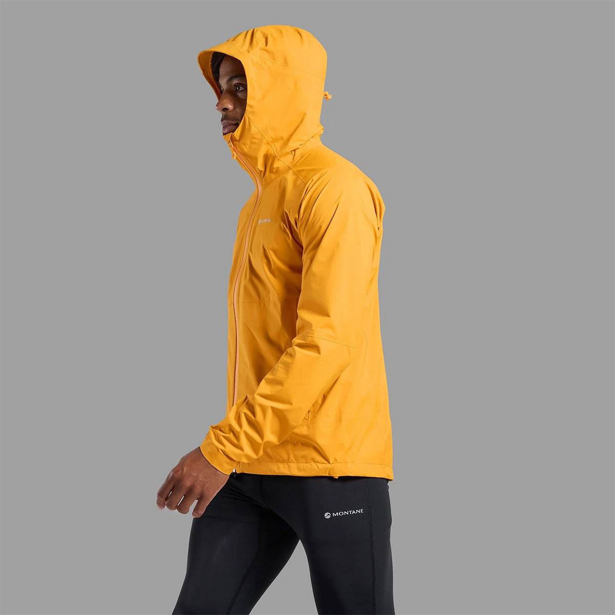 Side profile of Montane Mens Minimus Lite Waterproof Jacket in orange, designed for mobility and comfort during endurance sports.