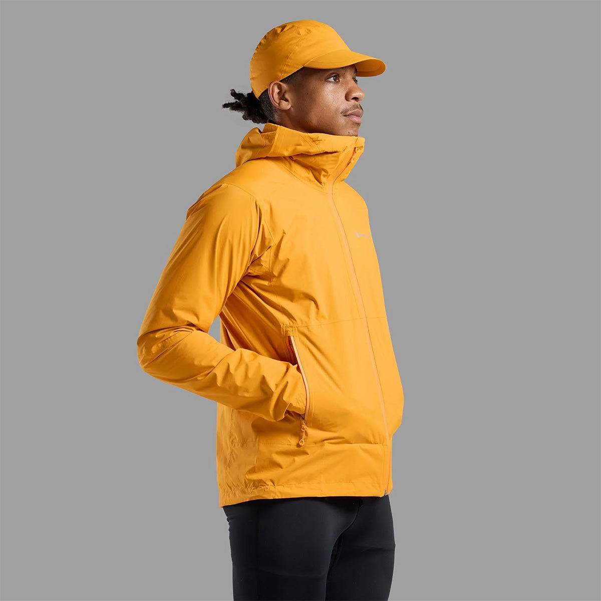 Montane Mens Minimus Lite Waterproof Jacket in orange shown in side view, highlighting zip pockets and streamlined silhouette.