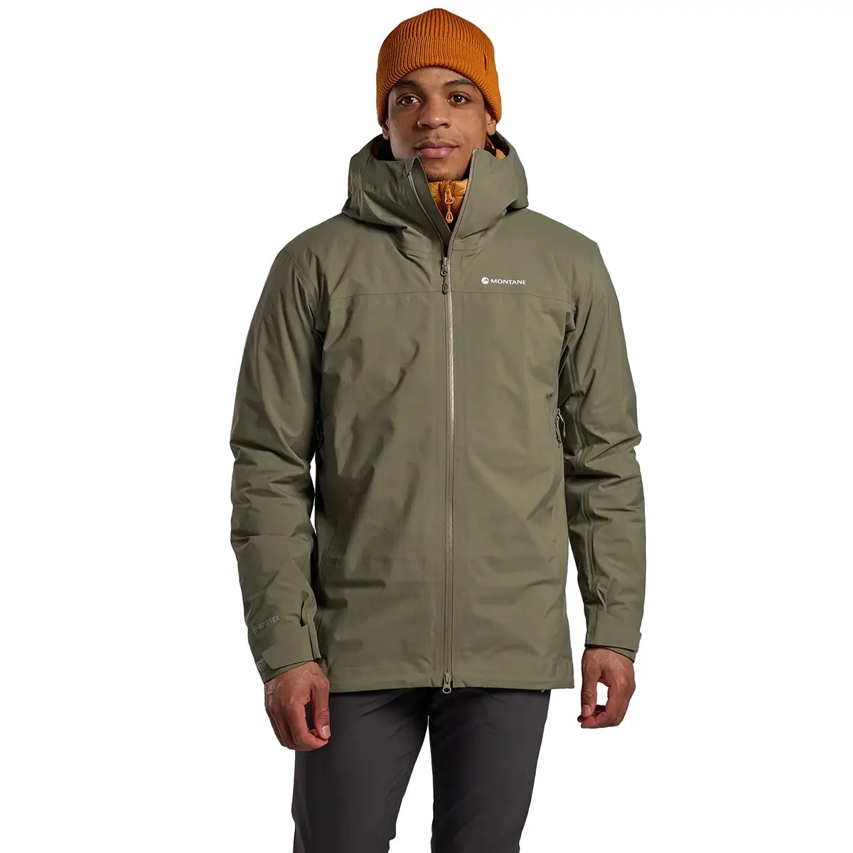 Front view of model wearing Montane Mens Phase Goretex Waterproof Jacket in green, ideal for hiking and wet weather conditions.