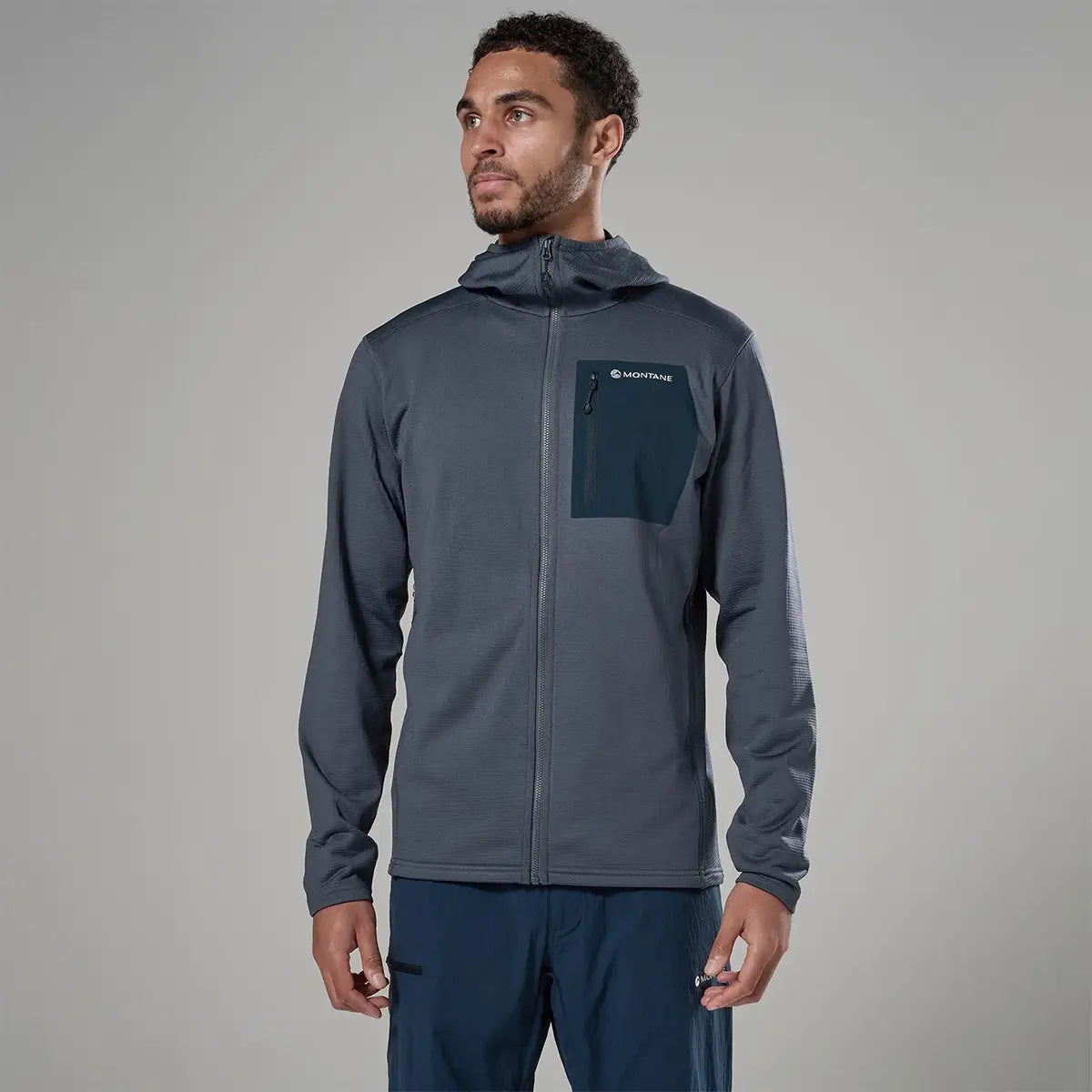 Model wearing Montane men's Protium CP hoodie fleece jacket in navy, outdoor activewear jacket