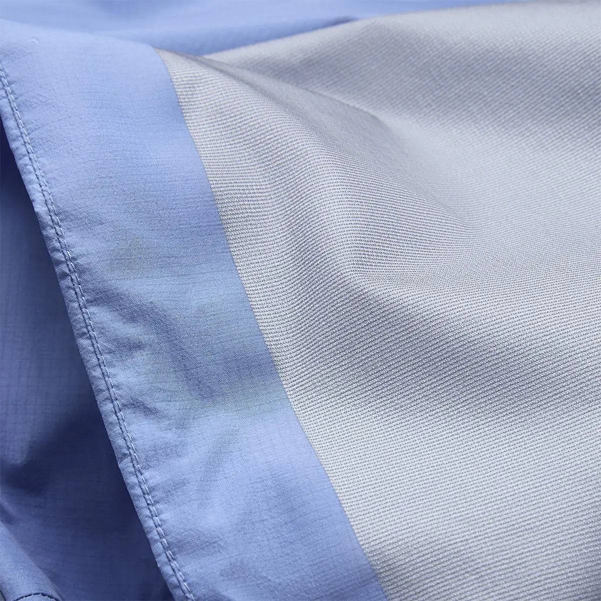 Close-up of Montane Women's Cetus Lite Waterproof Jacket fabric in light blue, showing its waterproof and breathable material.