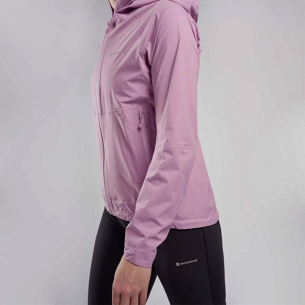 Side view of pink Montane Womans Minimus Lite Waterproof Jacket worn by woman, showing zippered pockets and athletic fit for performance wear.