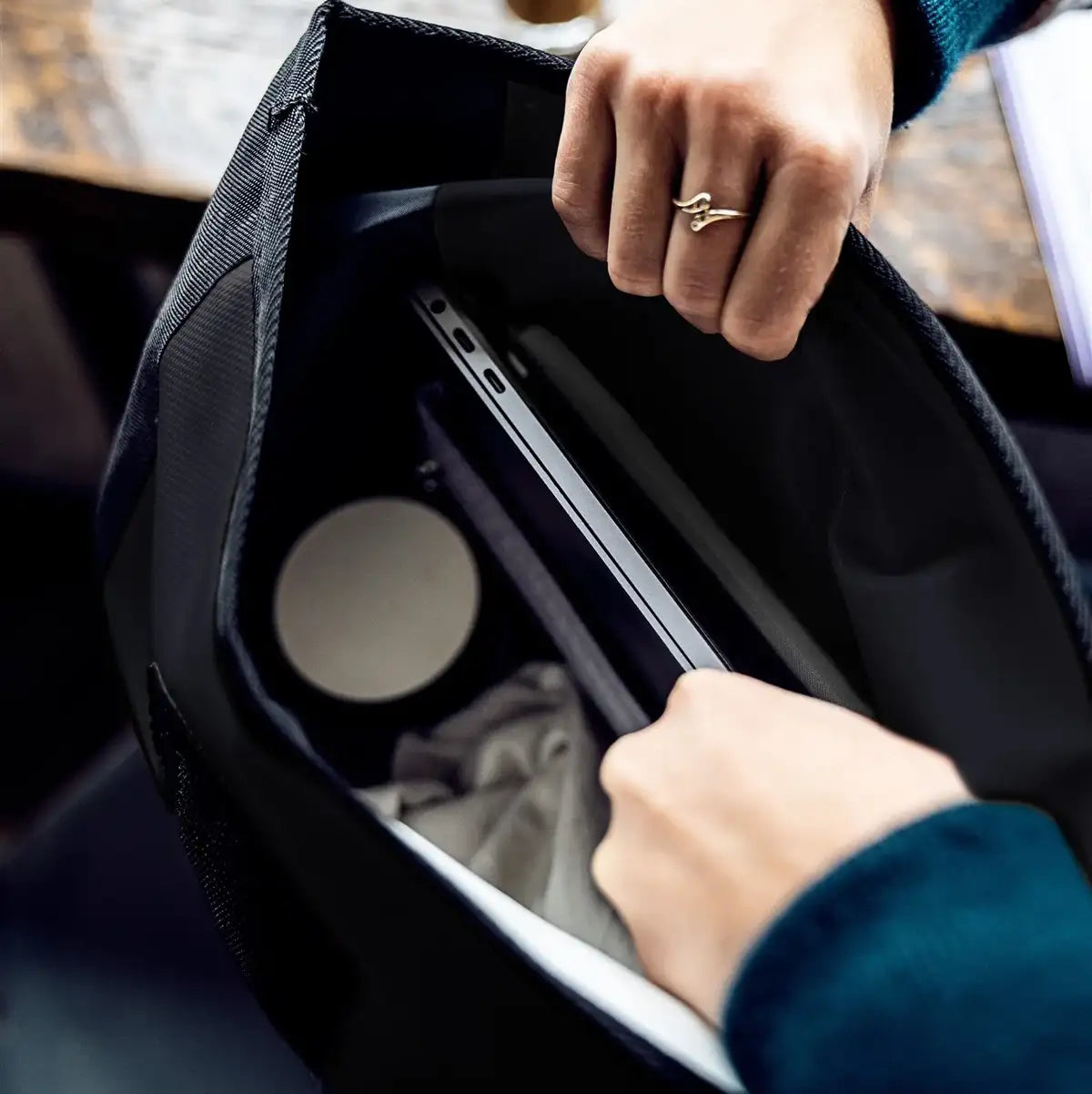 Close-up of Ortlieb Velocity 23L Dry Backpack in use, displaying laptop and daily essentials inside the waterproof main compartment.