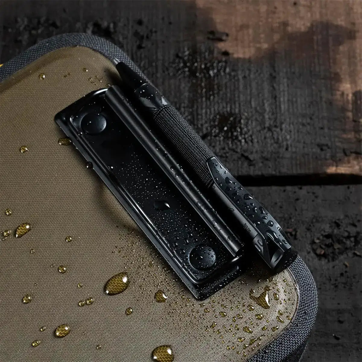Close-up of water droplets on the water-resistant fabric surface of the Rite in the Rain waterproof A5 desk holder, showing durability in wet conditions