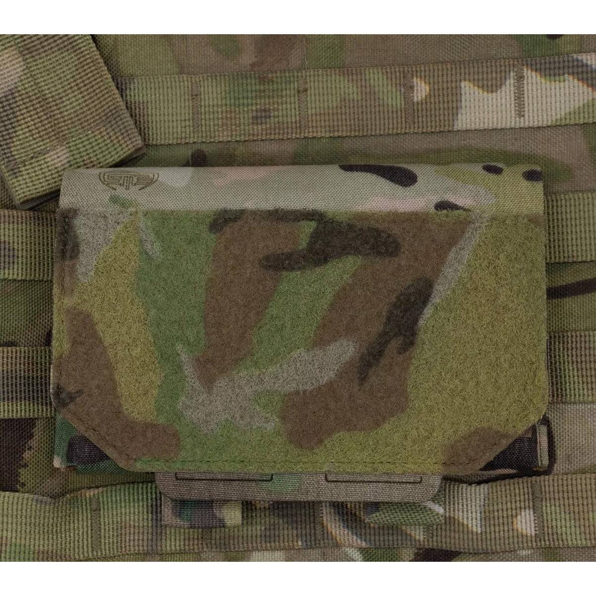 Spectre Admin Sleeve Multicam securely mounted on MOLLE webbing, showcasing its compact tactical design for field use.