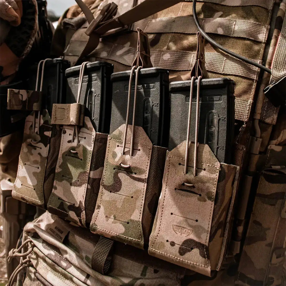 Spectre Quad Elastic Magazine Pouch MTP by John Bulls mounted on tactical vest, holding four rifle magazines in multicam pattern for military use. from John Bull Clothing