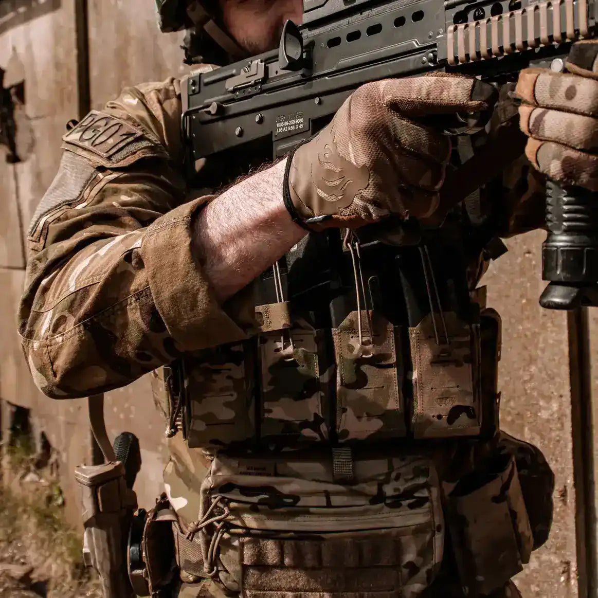 Operator wearing Spectre Quad Elastic Magazine Pouch MTP during tactical training, demonstrating quick-access magazine storage in multicam gear setup. from John Bull Clothing