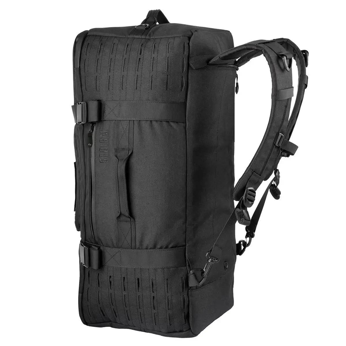 Stoirm 50L Black Duffel Bag in an upright position with padded backpack straps and MOLLE webbing for tactical use.
