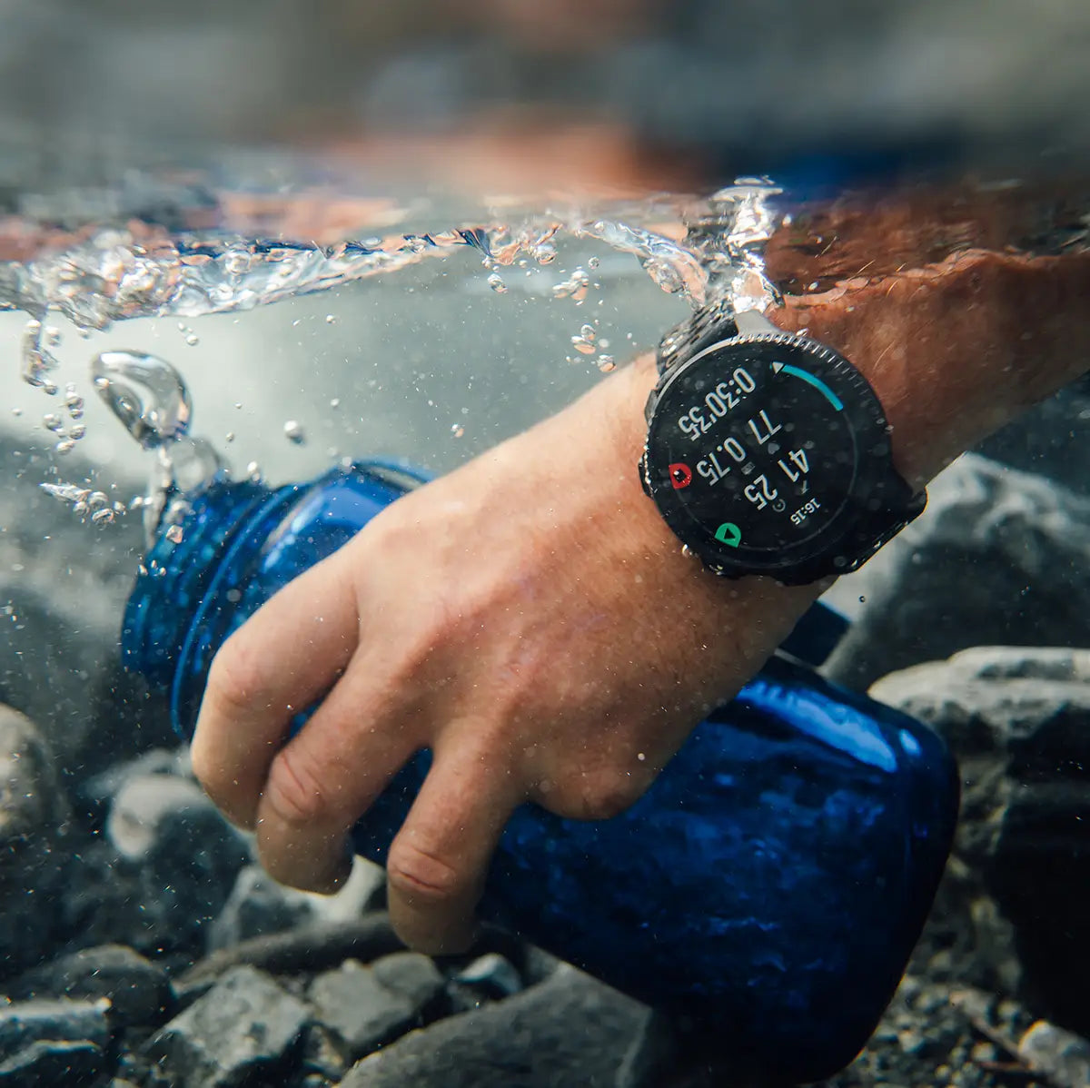 Suunto Vertical 2 GPS Fitness Watch submerged in water, showcasing waterproof design and durability for extreme conditions.